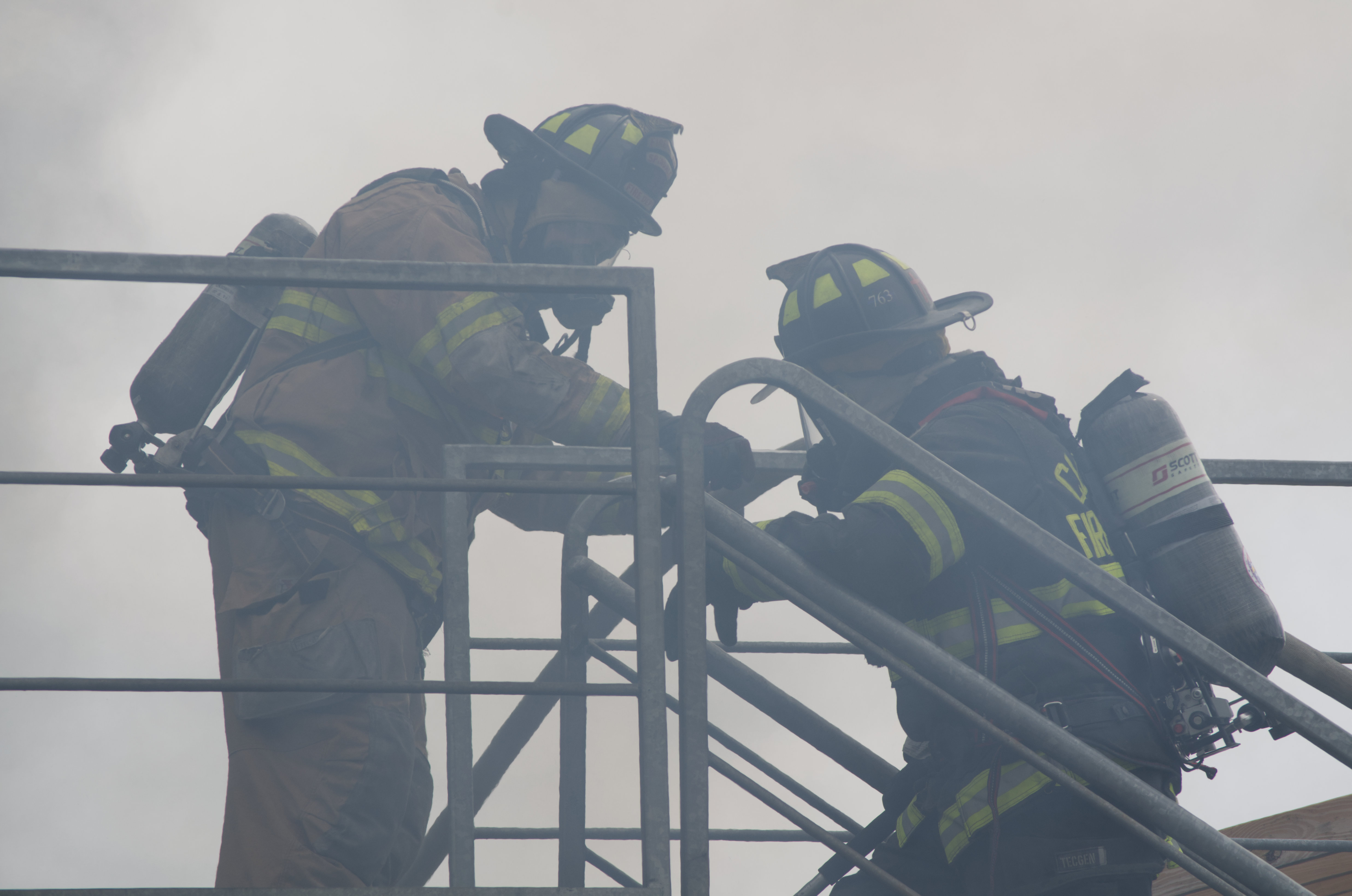 two fighters climbing stairs while surrounded with smoke