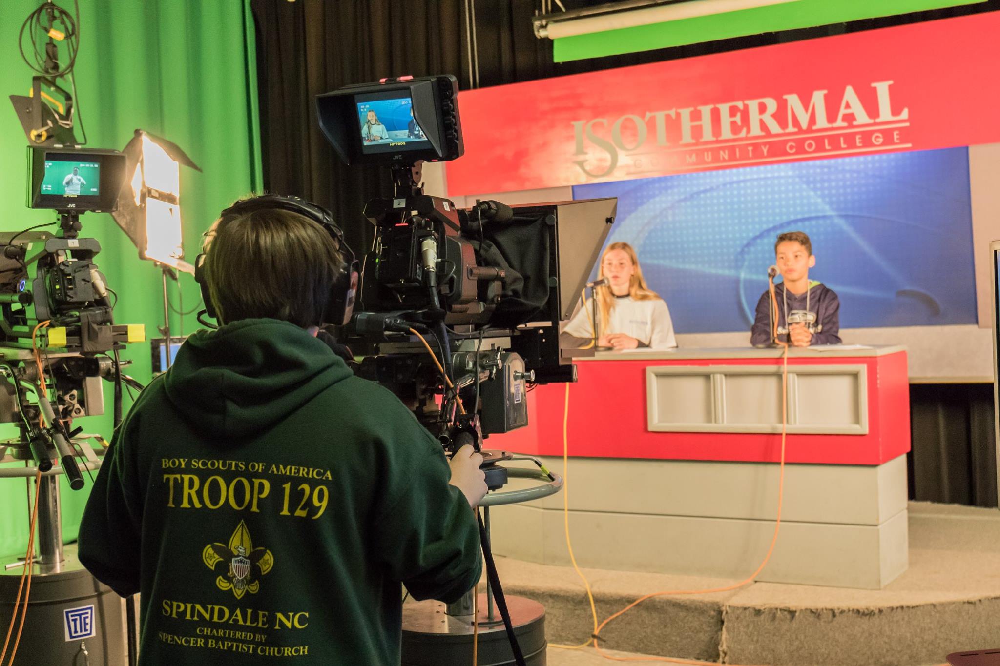 Students filming news segment in Broadcasting Studio
