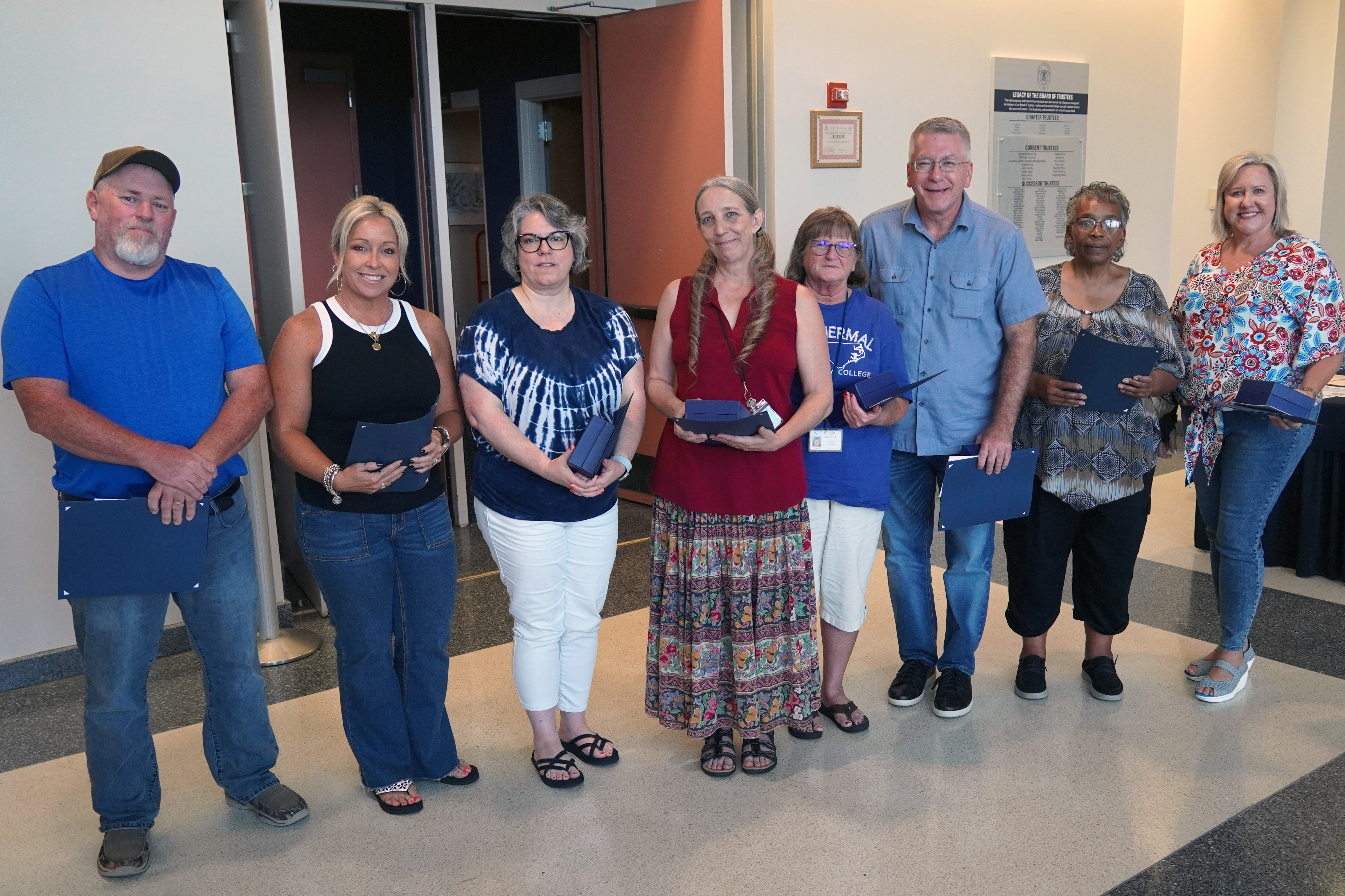 ICC employees pose for a picture with their awards.