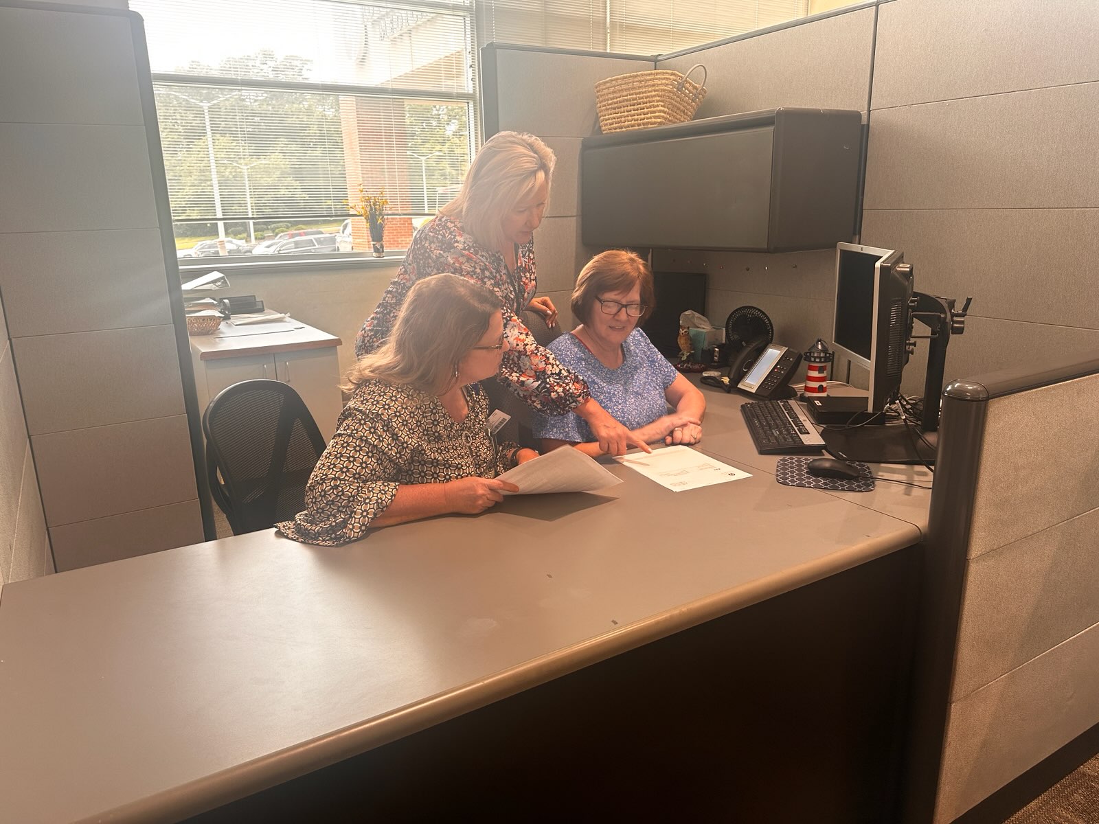 Cooper, Philyaw, and Miller sitting at a computer.