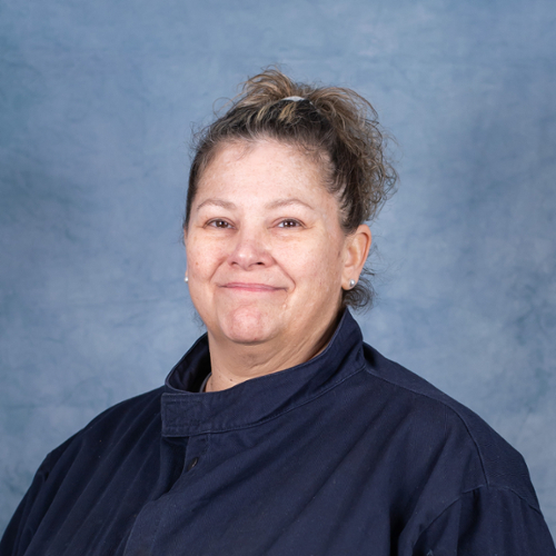 Headshot of Joy Thomson on blue background