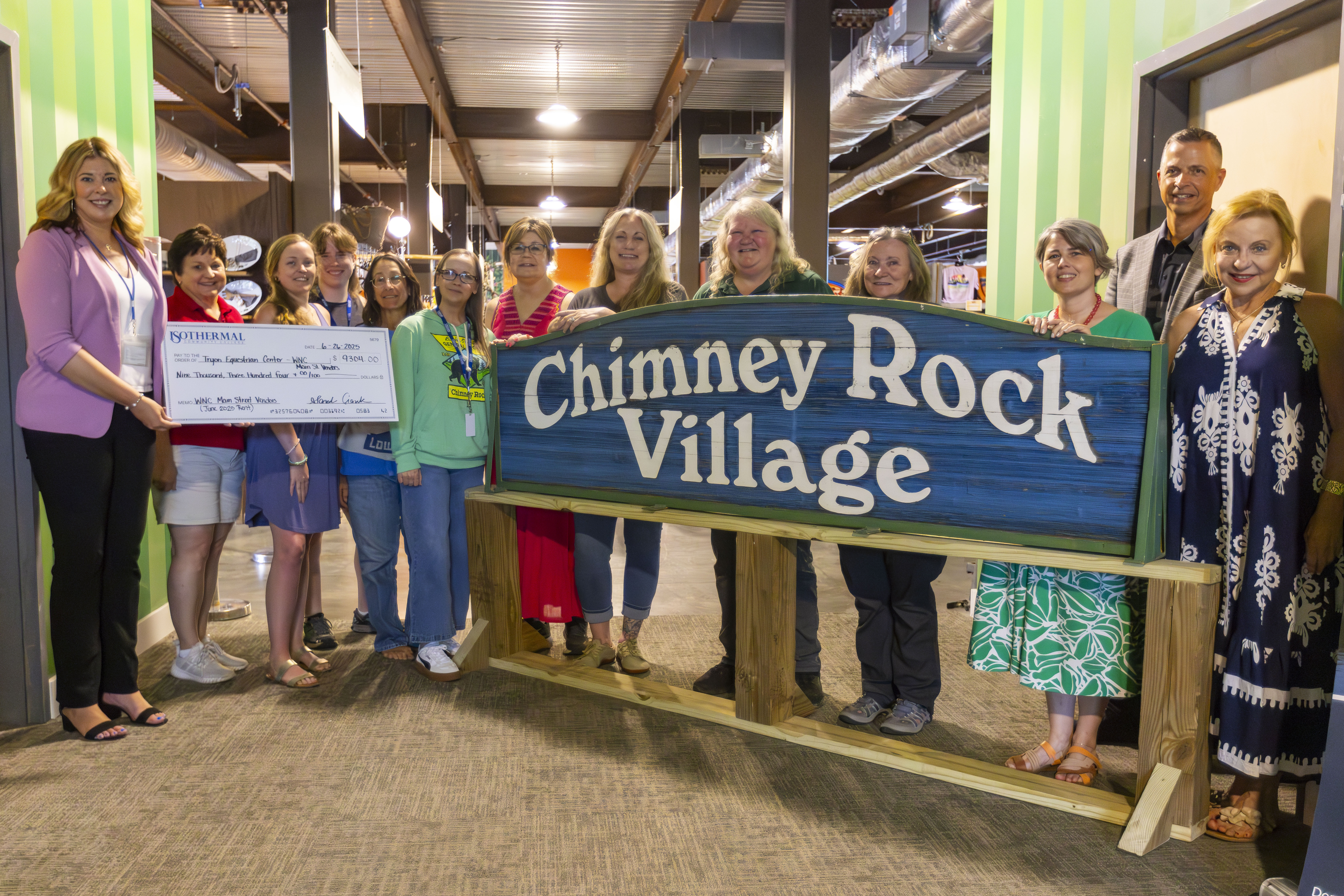 Group of small business owners posing with a check at the Tryon International Equestrian Center