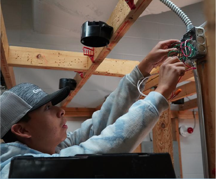 student working on a electrical housing for lighting